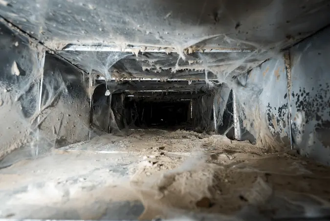 Dirty HVAC unit with dust buildup inside air ducts