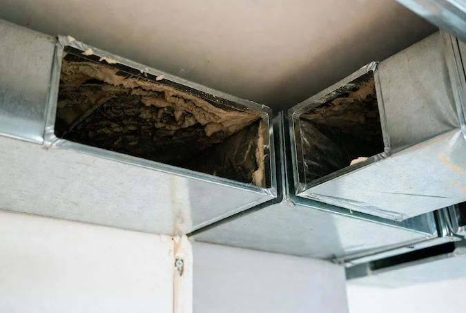 Heavy dust and debris buildup inside neglected air ducts